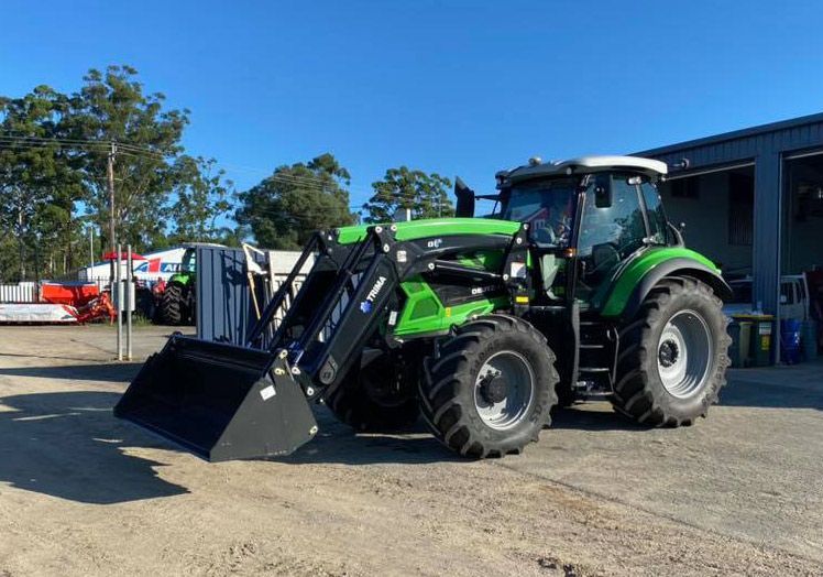 Green Tractor Loaders Parked Outside the Shop — Thompson's Farm Gear In Kempsey, NSW