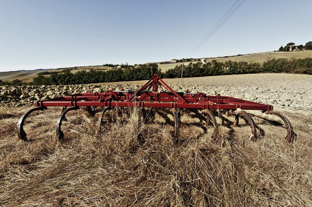 Harrow on Ploughed Field in Agricultural Landscape — Thompson's Farm Gear In Taree, NSW