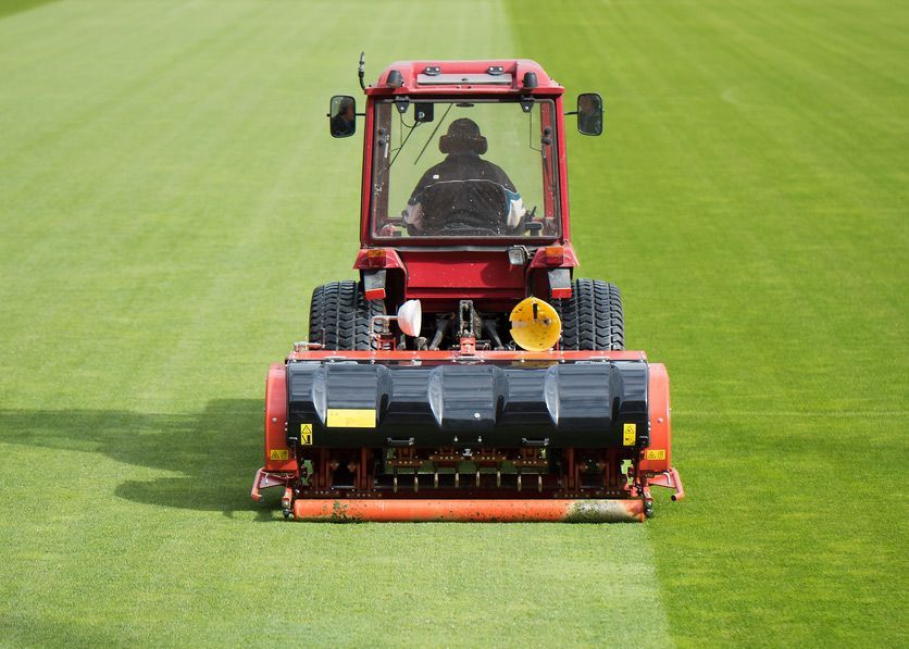 Man Driving Tractor to Cut Grass — Thompson's Farm Gear In Wingham, NSW