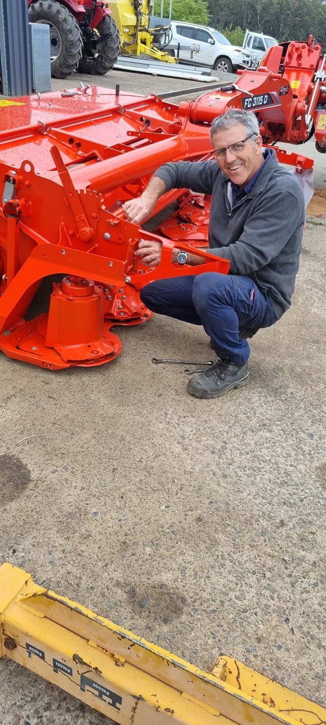 Smiling Man with Agricultural Machinery — Thompson's Farm Gear In Coffs Harbour, NSW