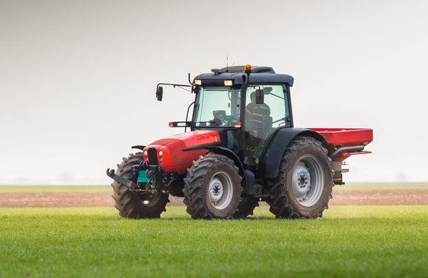 Tractor Spreading Fertilisers in Action — Thompson's Farm Gear In Wauchope, NSW