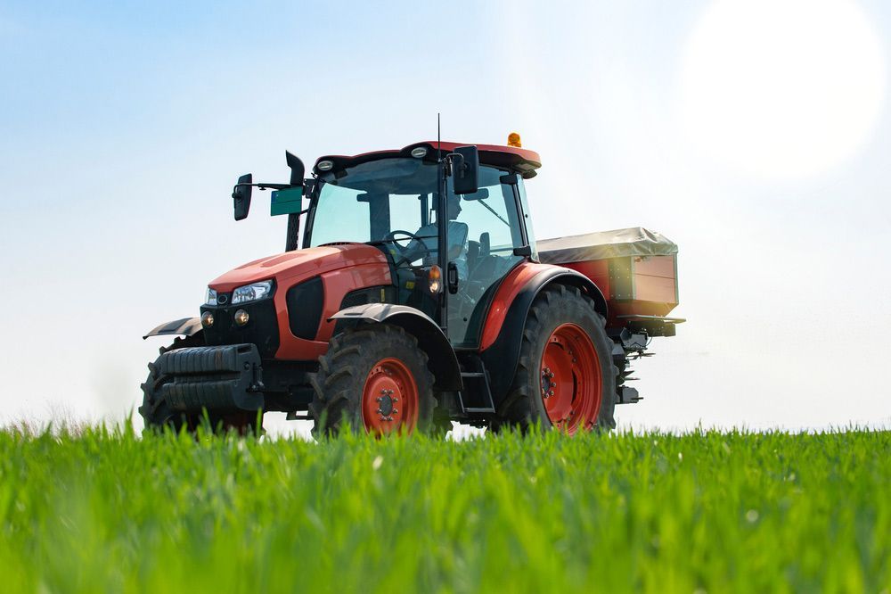 Tractor Equipped with Fertilizer Spreaders — Thompson's Farm Gear In Taree, NSW