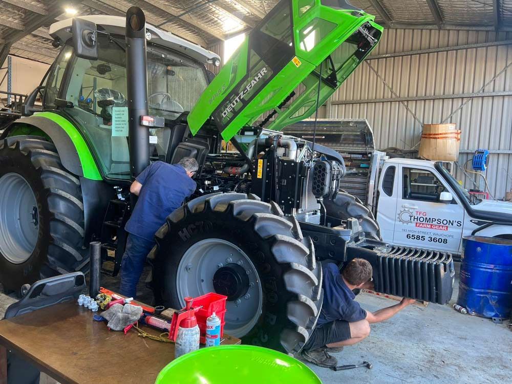 Mechanics Repairing a Deutz Fahr Tractor — Thompson's Farm Gear In Wauchope, NSW