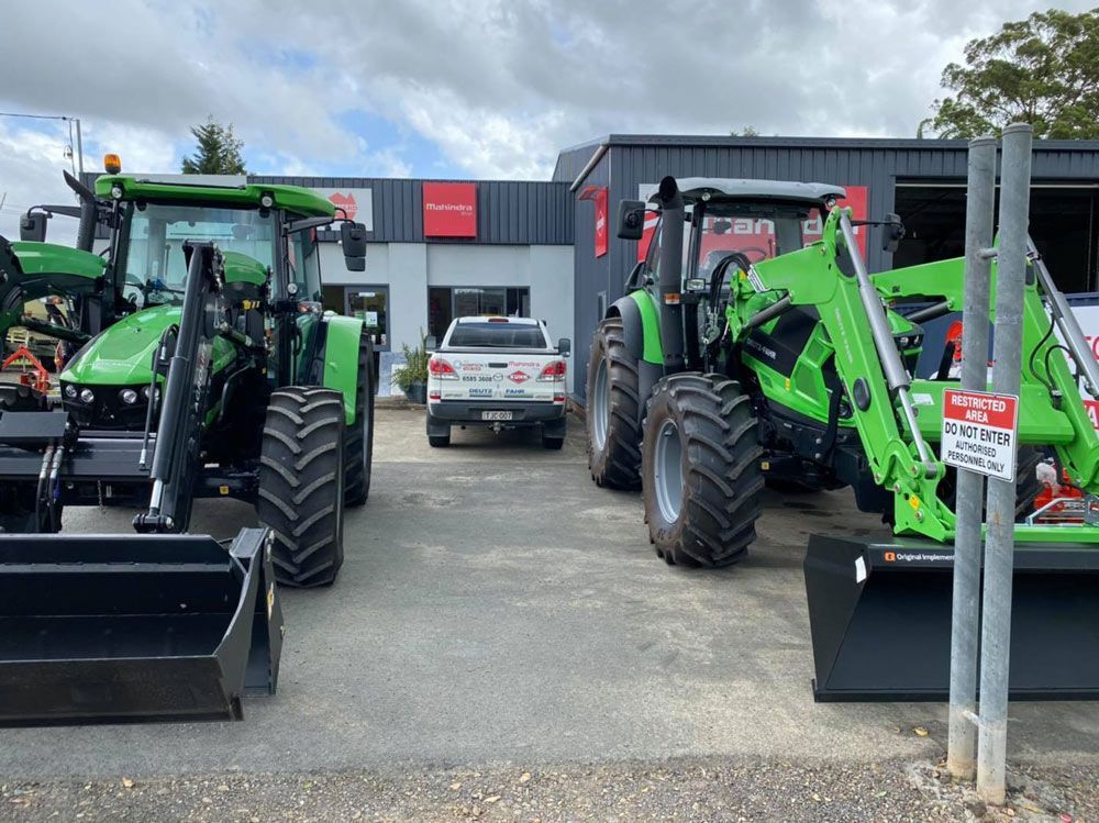 Two Tractors with a White Pickup Vehicle — Thompson's Farm Gear In Taree, NSW
