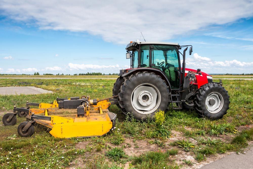 Wheeled Tractor Equipped with Rotary Mower — Thompson's Farm Gear In Wauchope, NSW