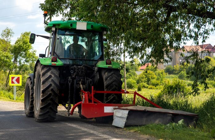 Tractor Cutting Green Grass with Precision Mowing Equipment — Thompson's Farm Gear In Wauchope, NSW