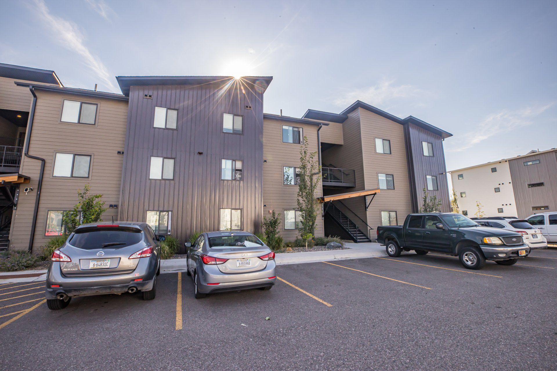 rosa apartments exterior with cars parked