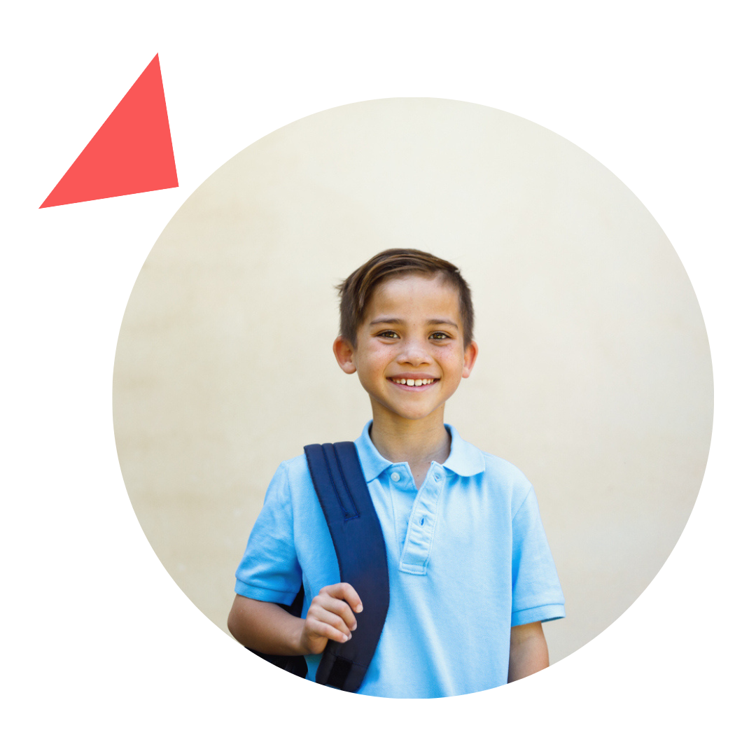 Boy with a backpack smiles, wearing a light blue polo shirt, standing in front of a beige background.
