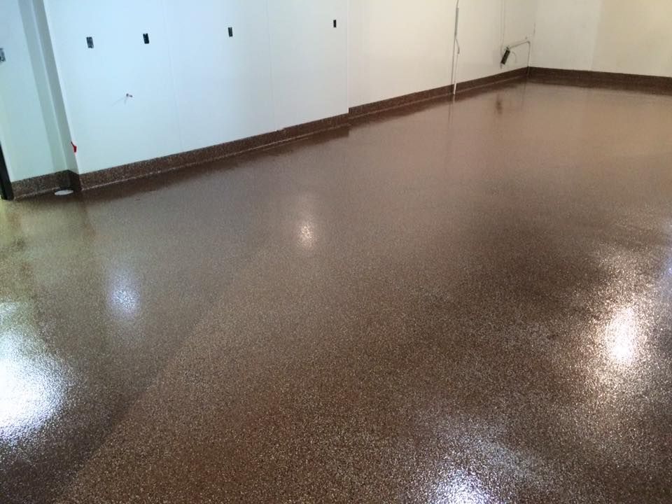 Empty room with glossy brown floor, white walls, and a doorway on the left.