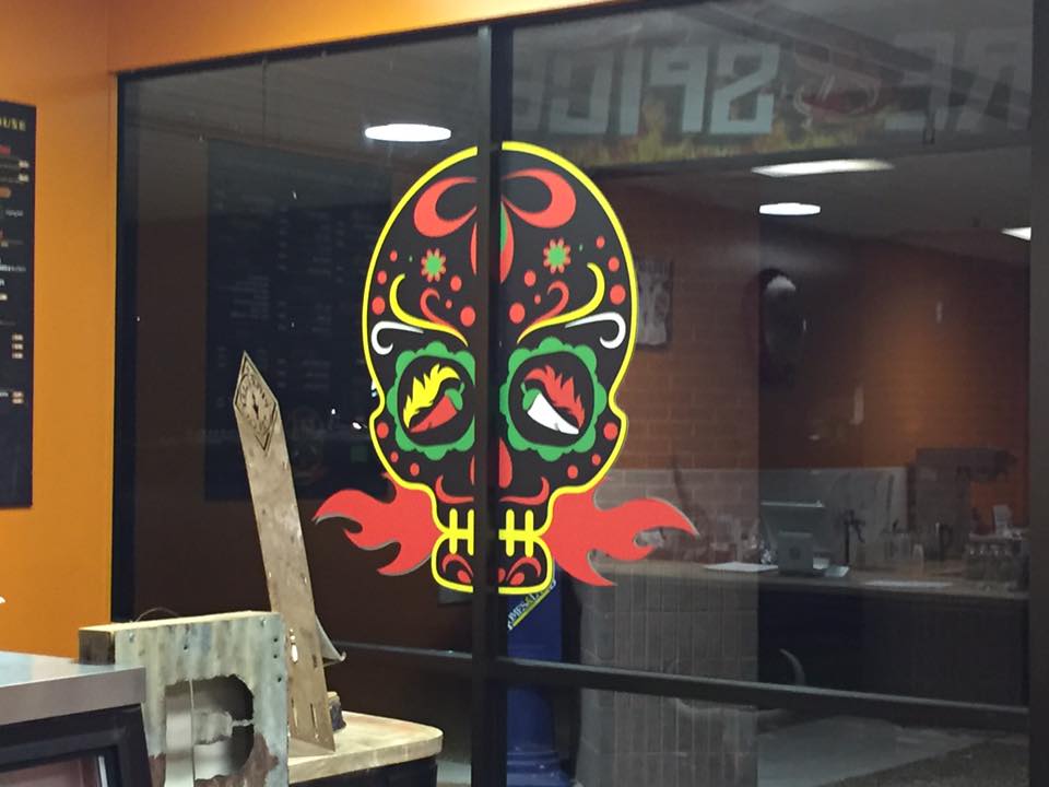 A glass door with a skull on it