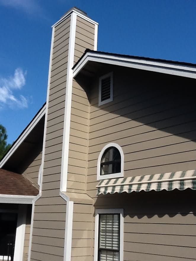 a house with a chimney on the side of it.