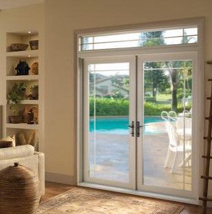 a living room with sliding glass doors leading to a pool.
