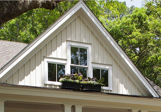 a white house with a window box on the roof