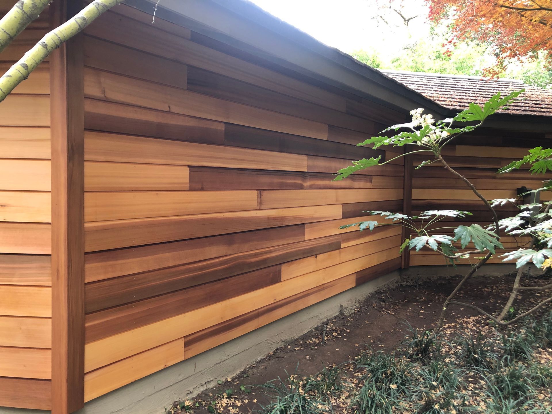 a house with a wooden siding on the side of it.