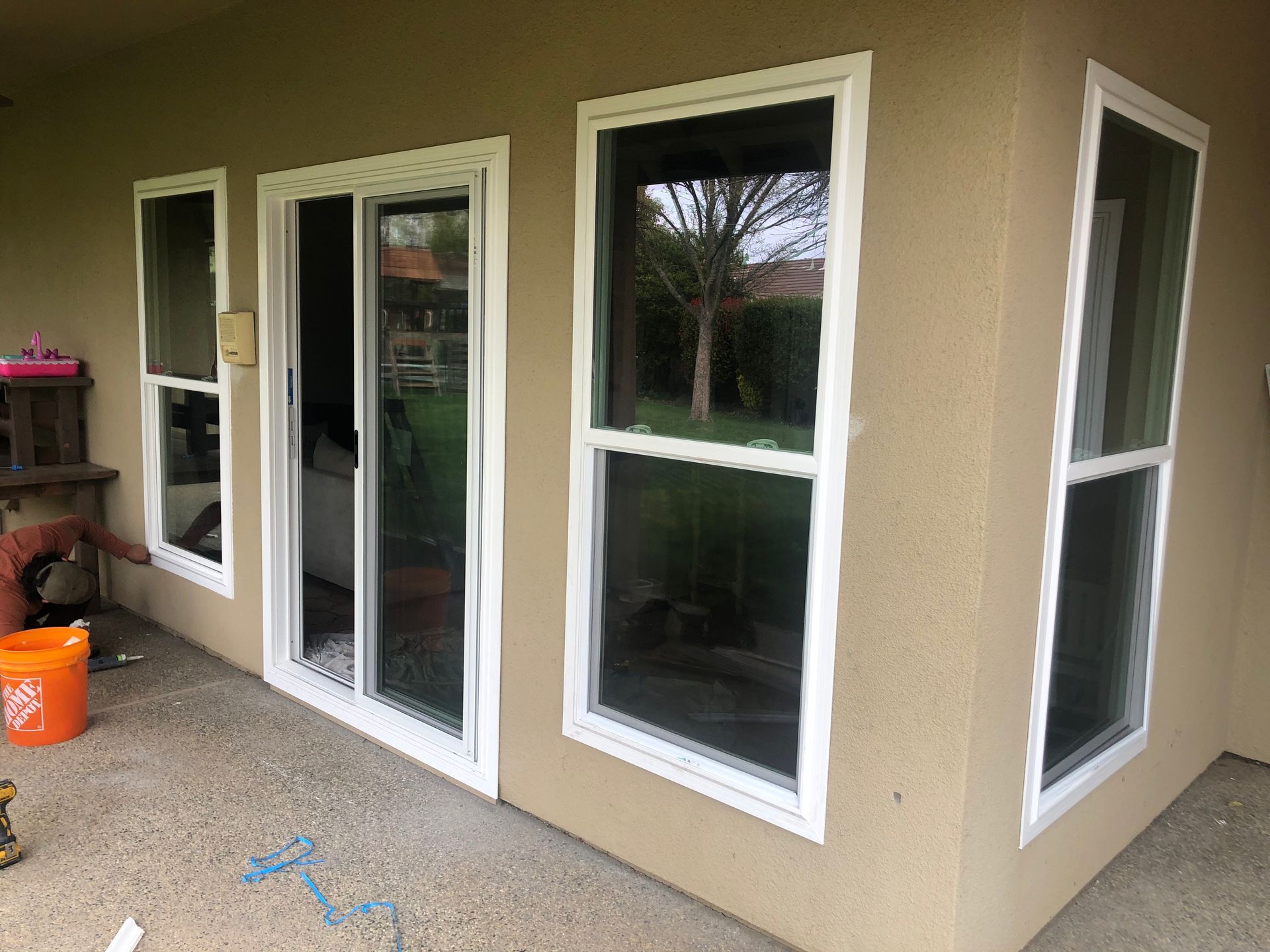 a house with a lot of windows and sliding glass doors.