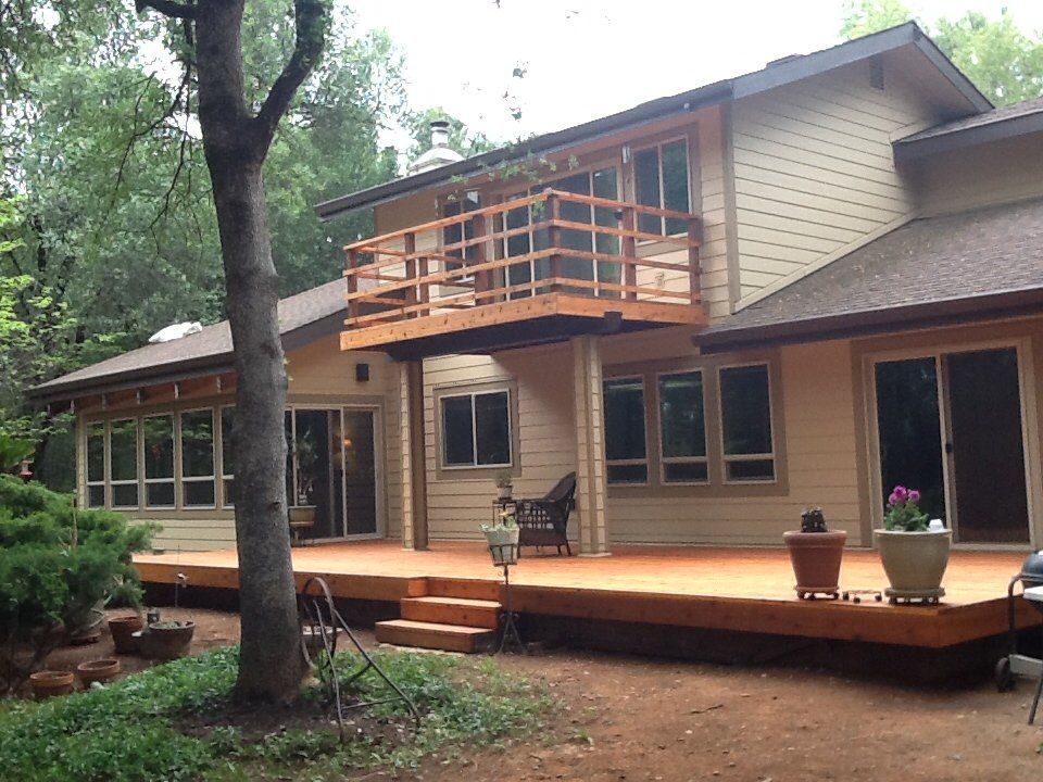 a house with a large deck and a balcony