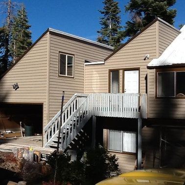 a house with stairs leading up to the second floor.