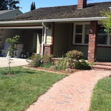 a house with a brick walkway leading to it.