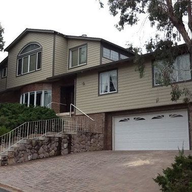 a large house with a white garage door.