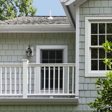 a house with a balcony and a window.