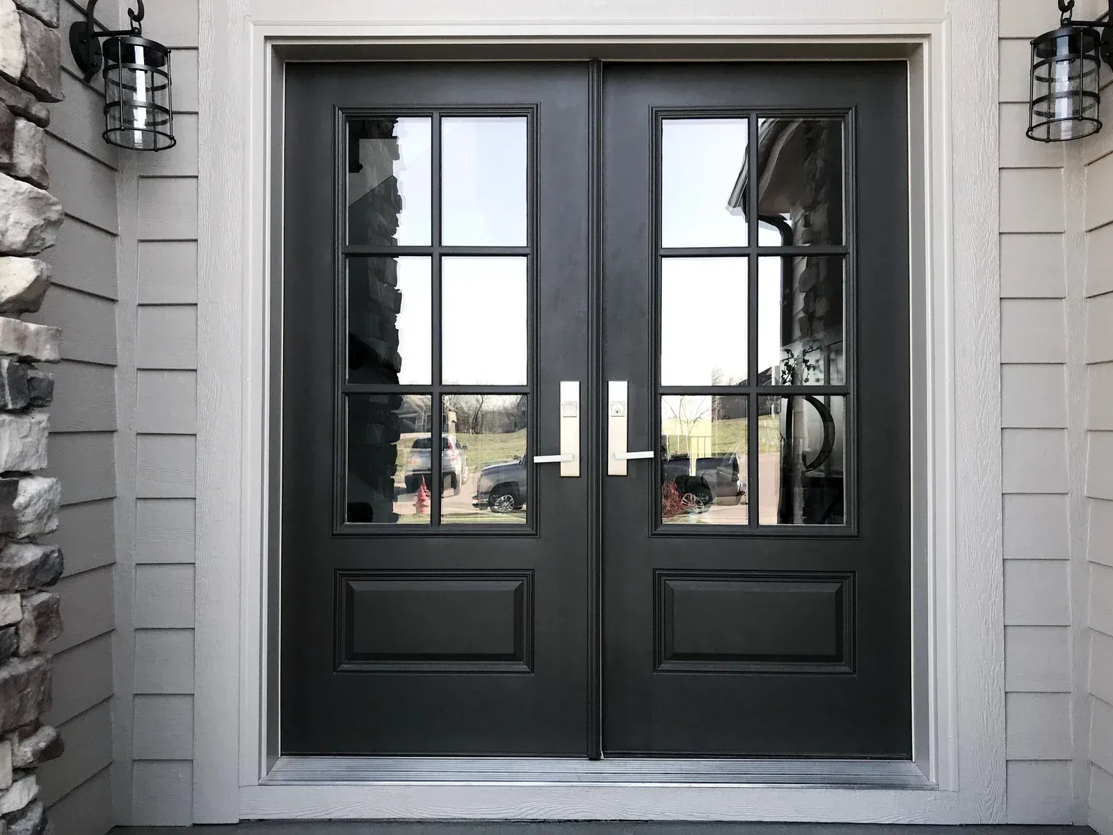 White metal security door with a glass side panel.