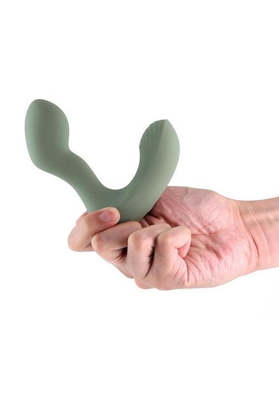 Hand holding a green U-shaped object on a white background