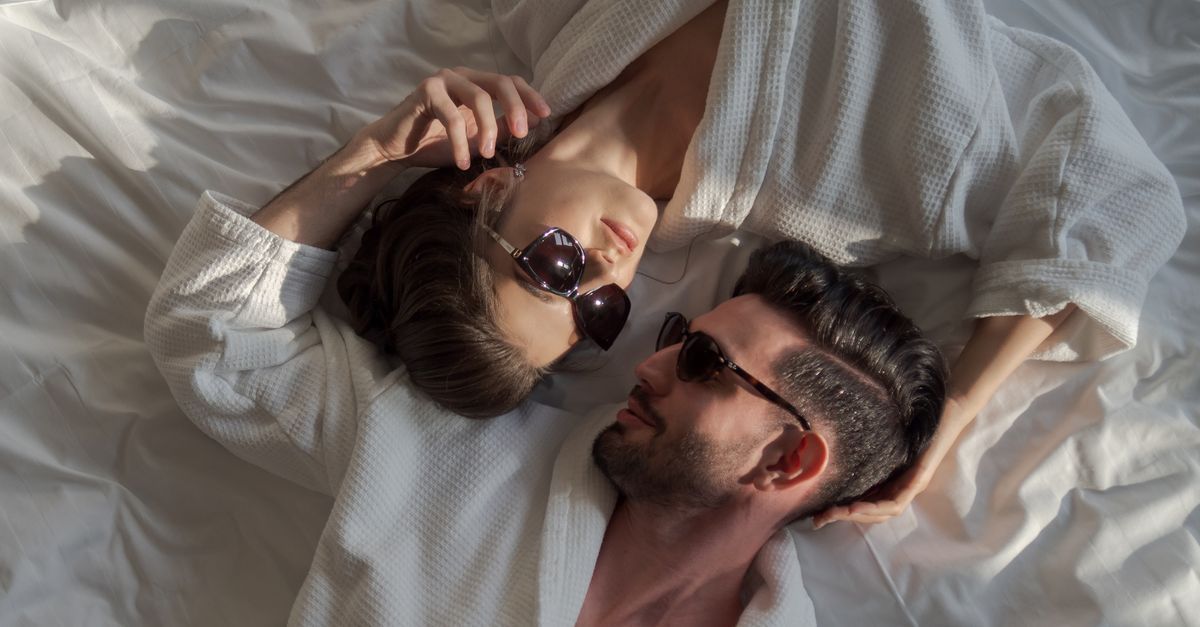Adult couple relaxing together in a calm bedroom after an intimate evening