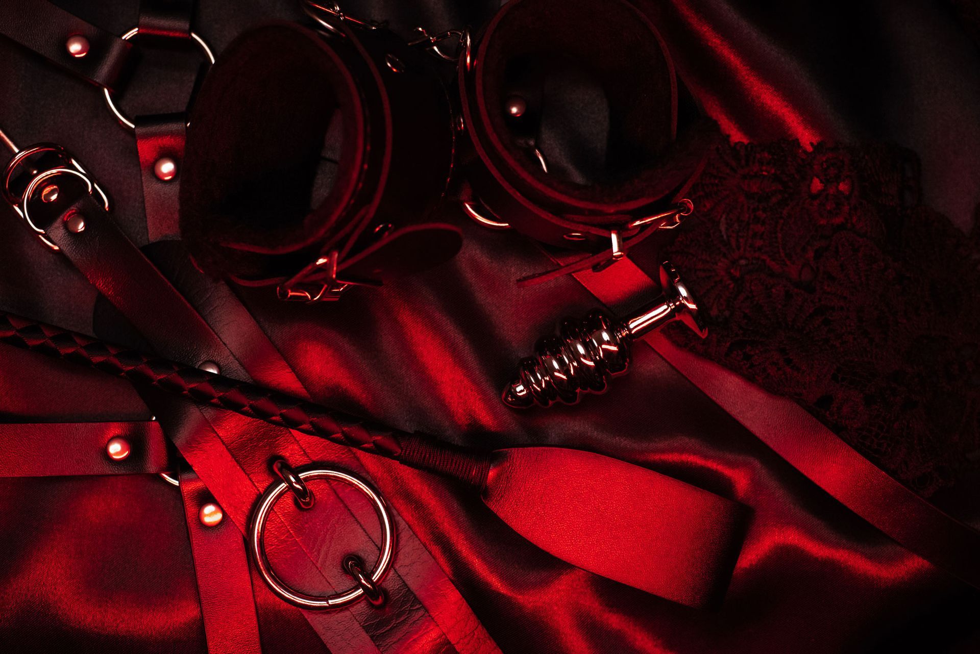 Bondage devices laying on a red table