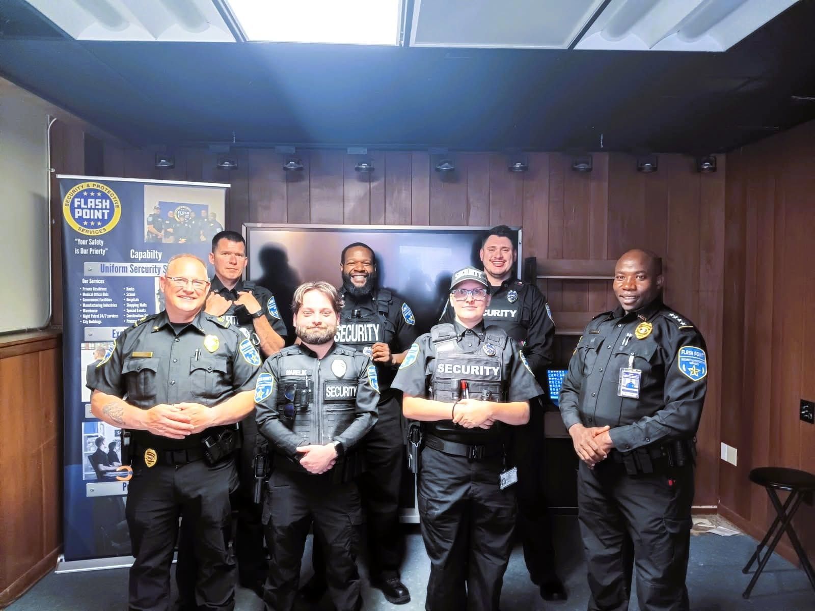 Six uniformed officers posing in a wood-paneled room during a police event