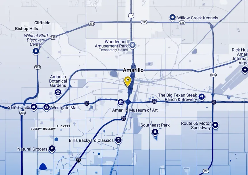 Blue-toned map with roads and route markers, centered on a highlighted location pin.