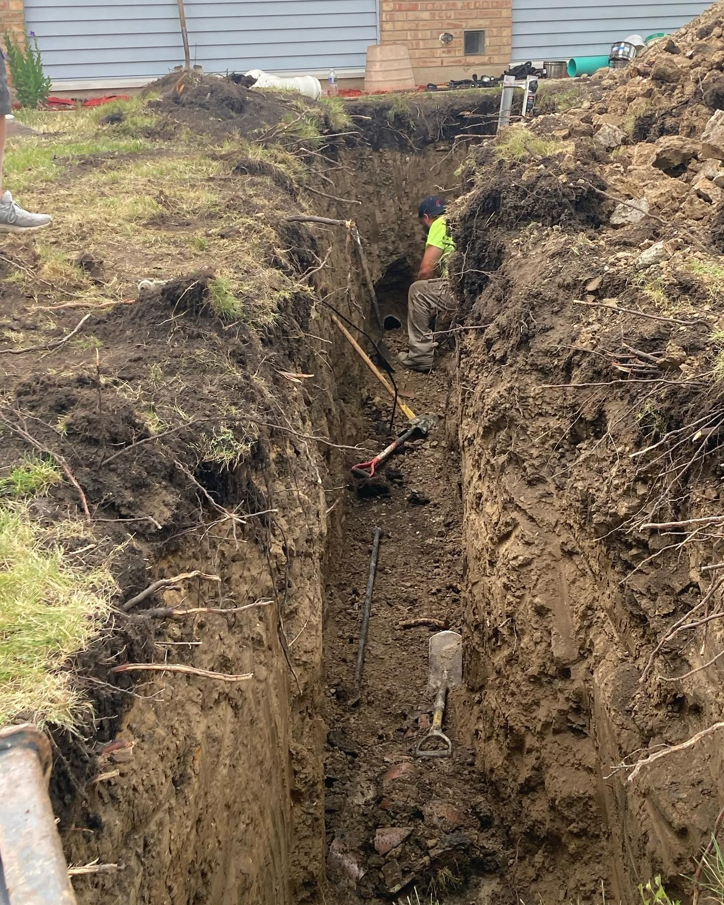 Sewer line repair and trench excavation for residential plumbing service
