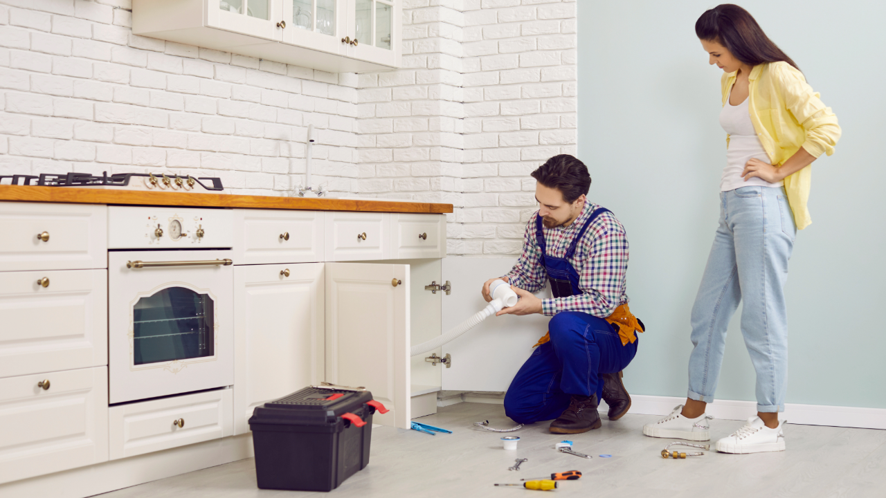Plumber installing kitchen sink drain for residential plumbing service in Chicagoland area