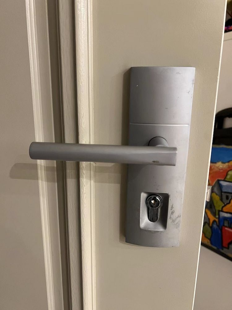 A Door Handle With A Key In It — Fortress Locksmiths & Security in Hornsby, NSW