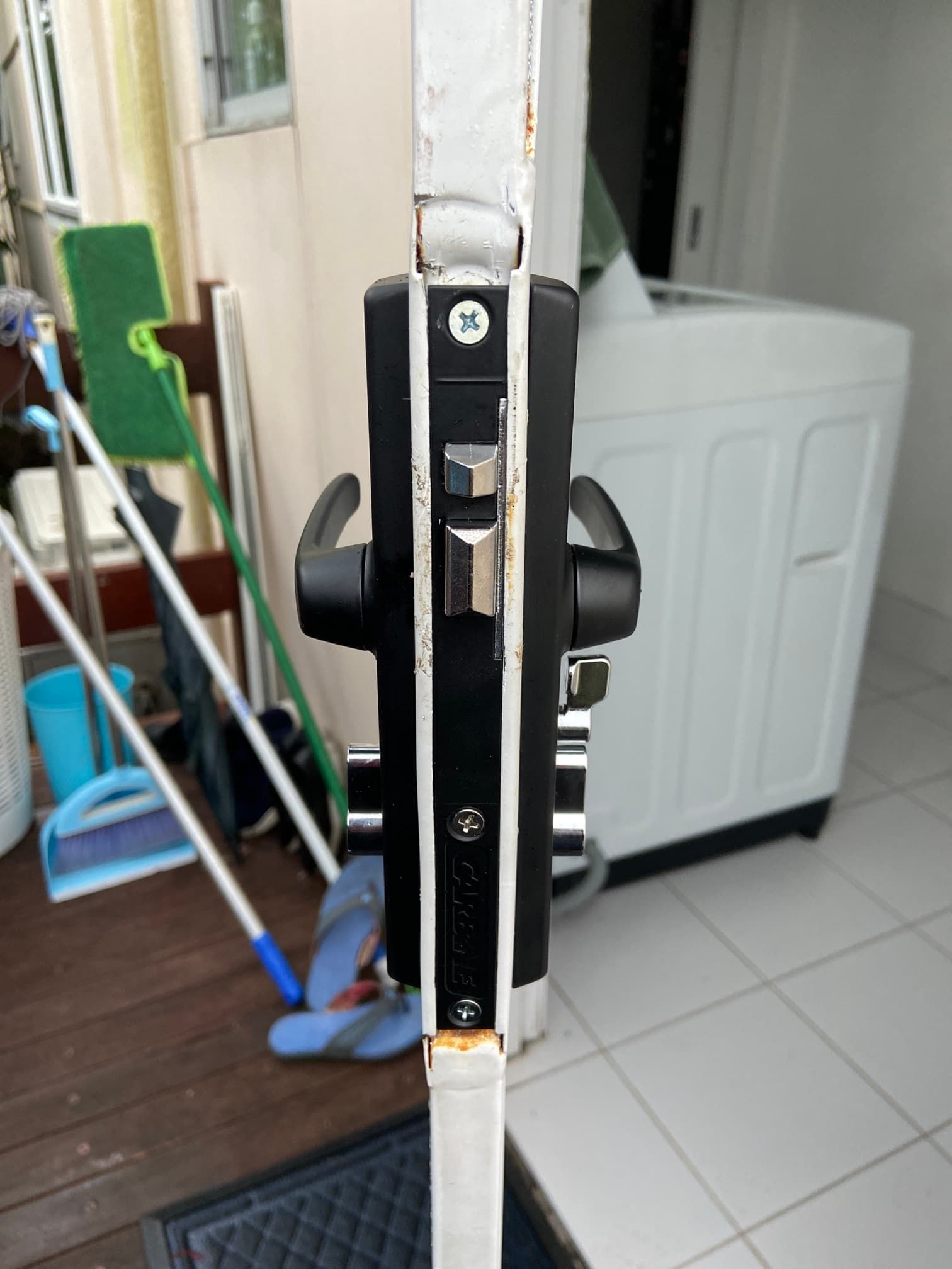 A Door Lock With A Washer In The Background — Fortress Locksmiths & Security in St Ives, NSW