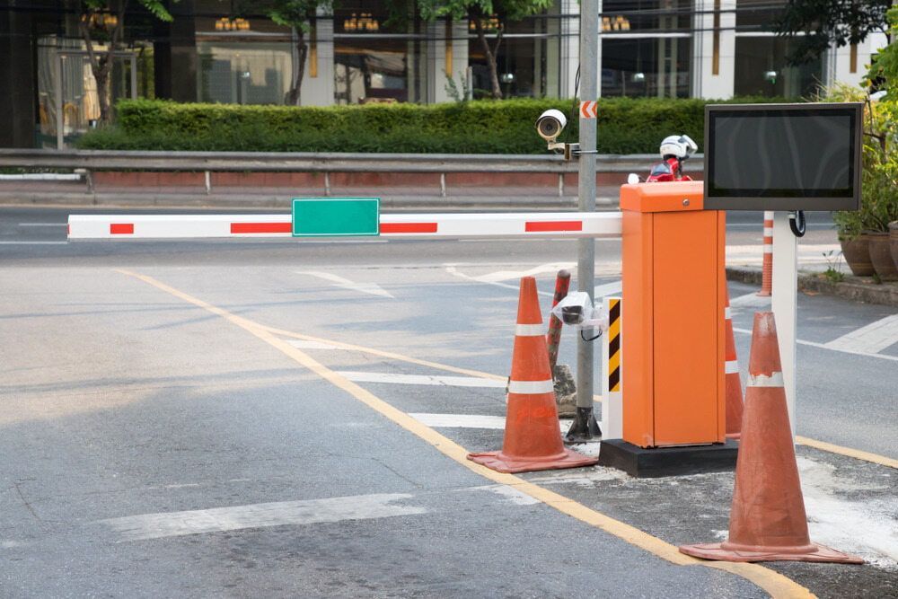 A Parking Lot With A Barrier And Cones On The Side Of The Road — Fortress Locksmiths & Security in Hornsby, NSW