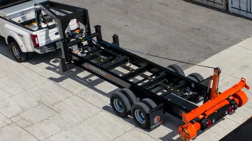 a containgo truck is towing a trailer 