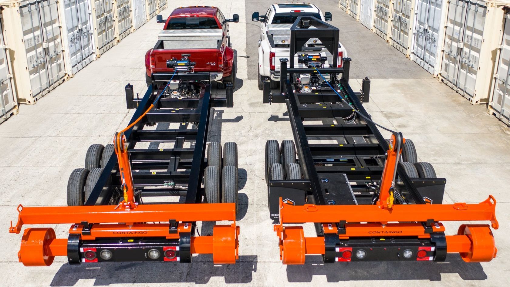 two trucks with containgo trailers attached to them