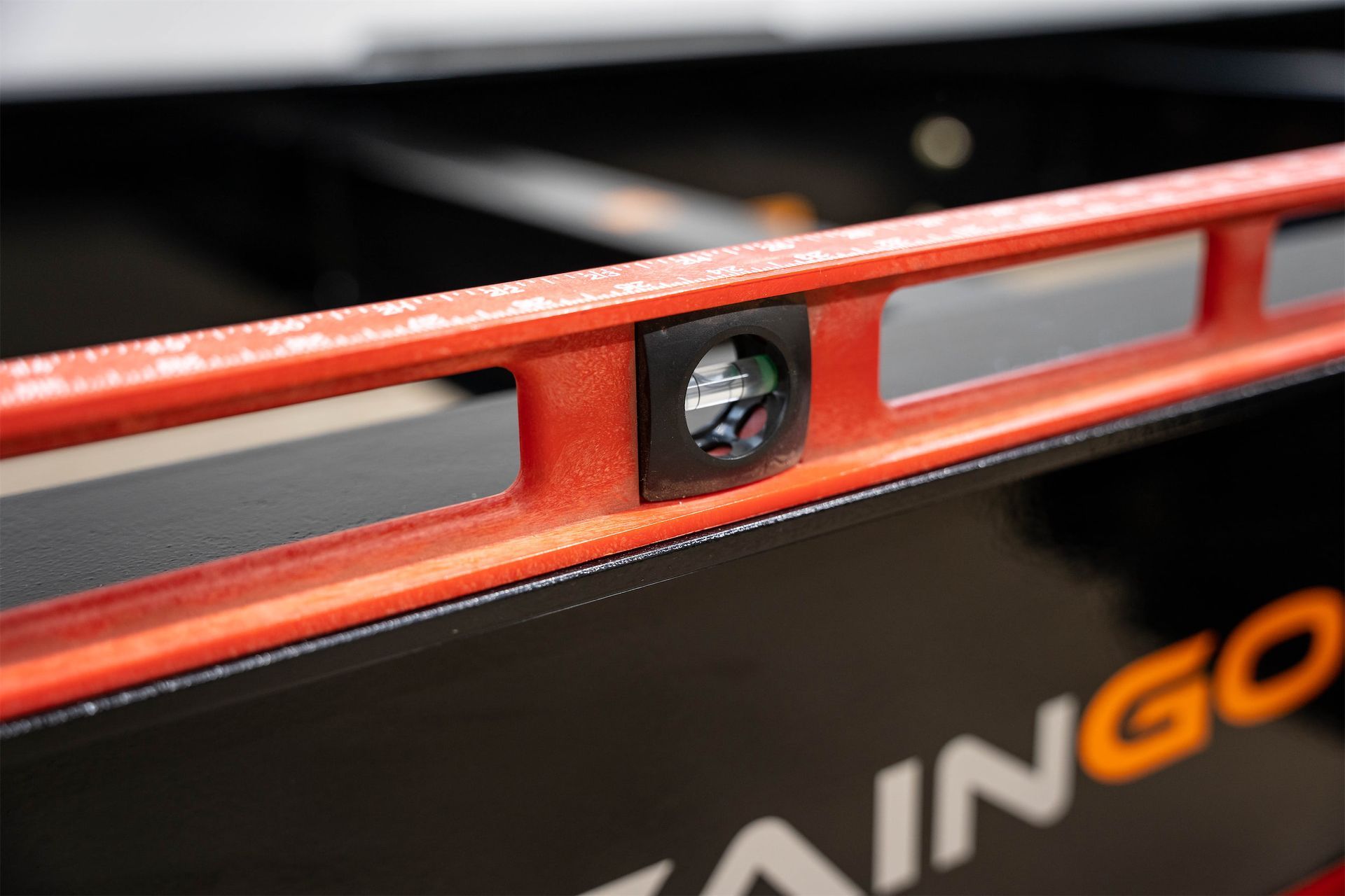 a red level is sitting on the container leveling chassis trailer