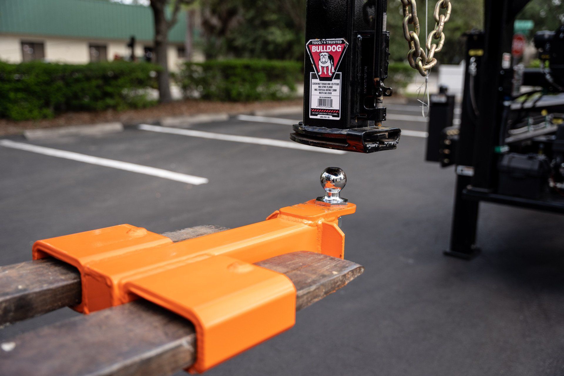 forklift attachment mounted on forklift forks picking up a trailer