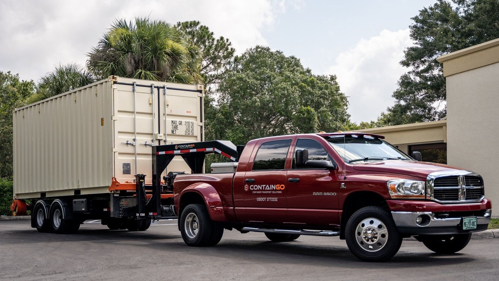 a containgo truck is towing a white shipping container