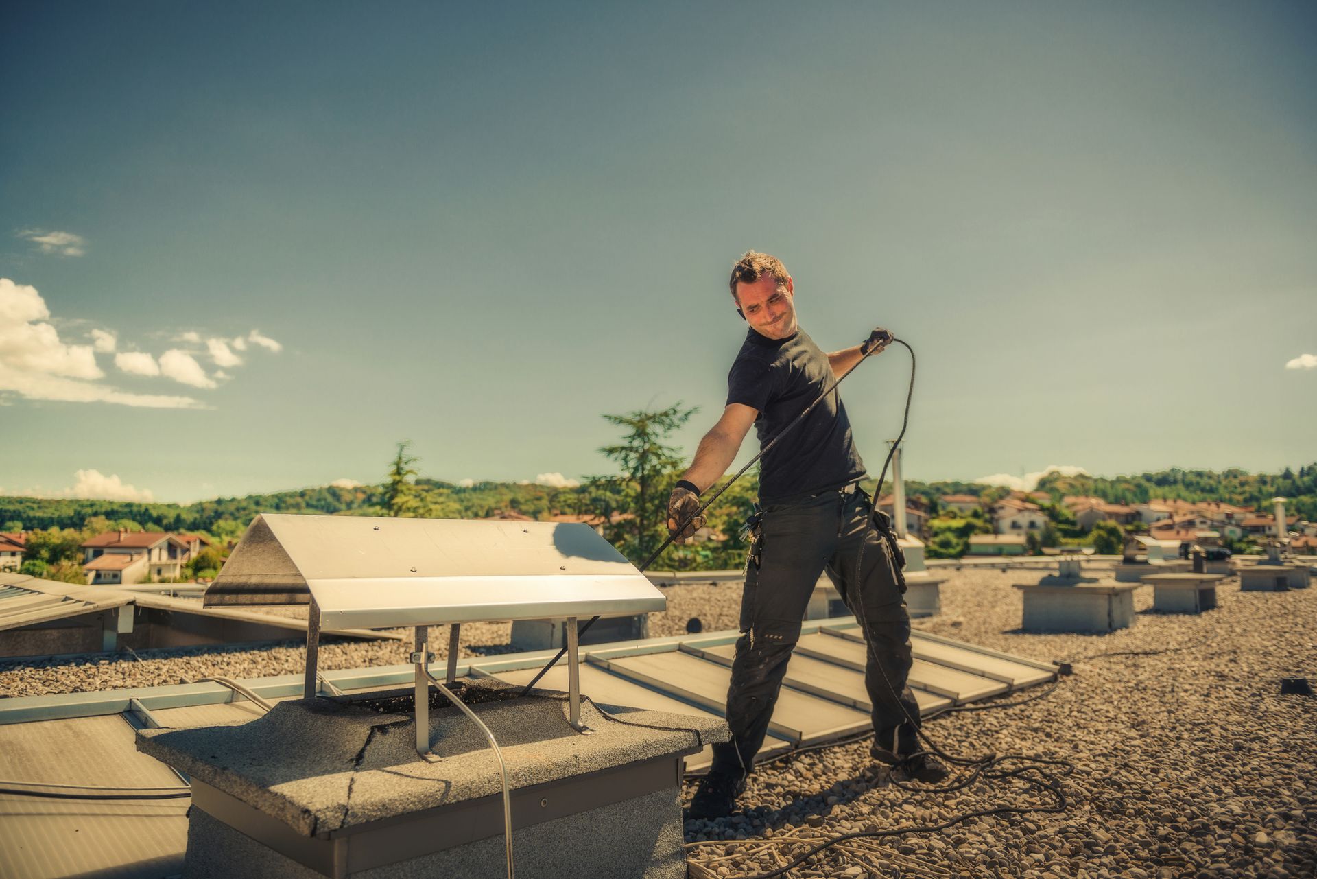 A man cleaning a chimney on a roof, showing safe work by chimney repair companies.