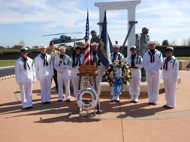 sailors in front of monument