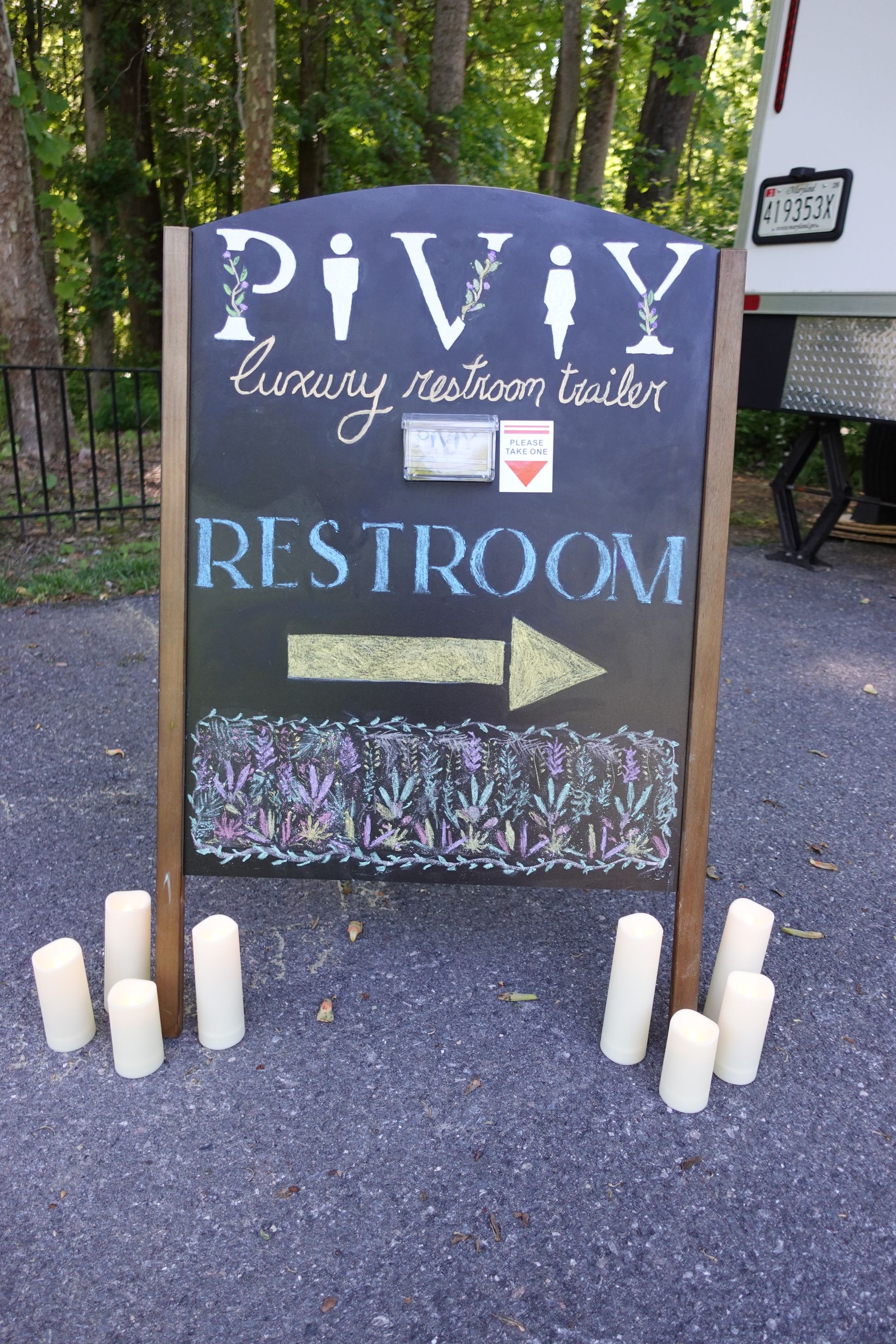A chalkboard sign shows the way to the piviy restroom