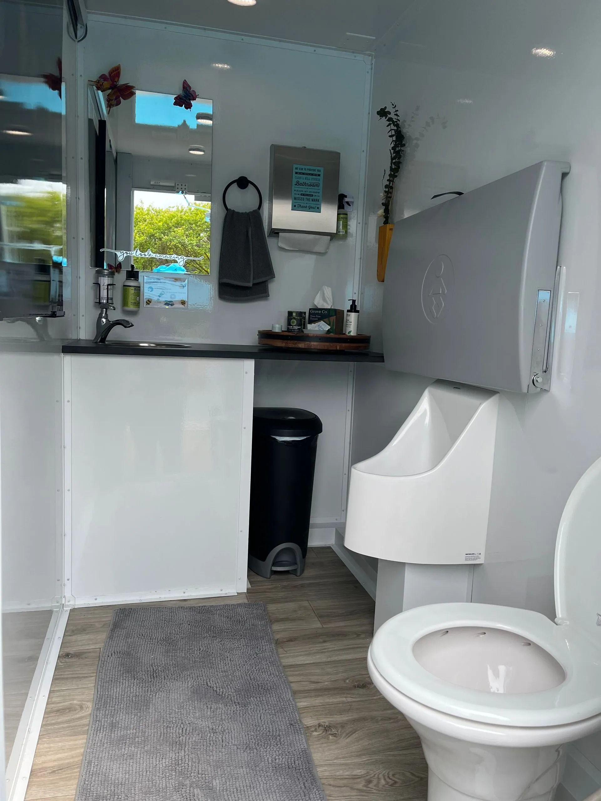 A bathroom with a toilet, urinal and sink.