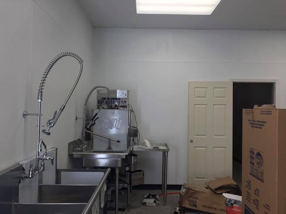A kitchen with a stainless steel sink and a dishwasher