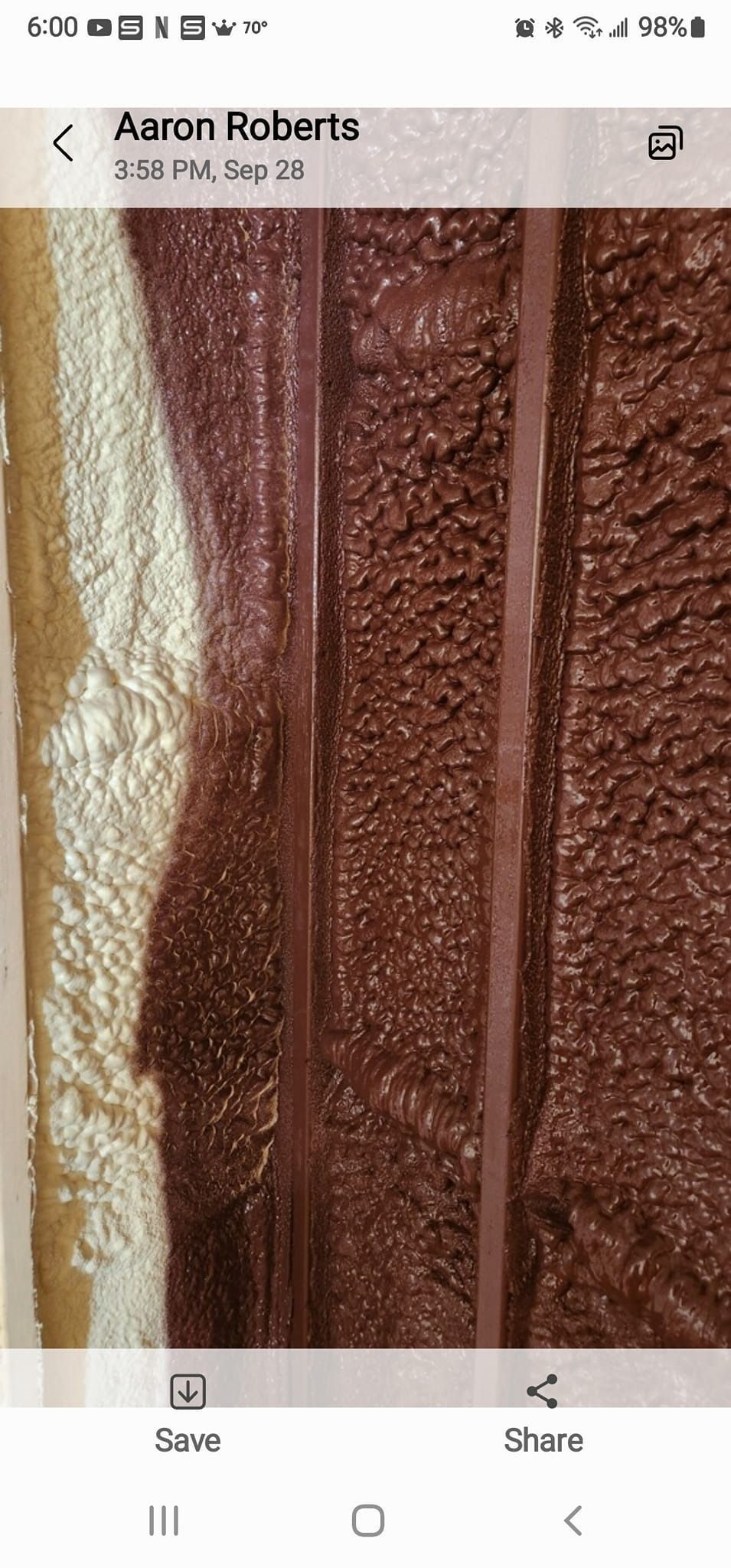 A close-up view of textured dark brown material with two vertical parallel lines against a lighter tan background.
