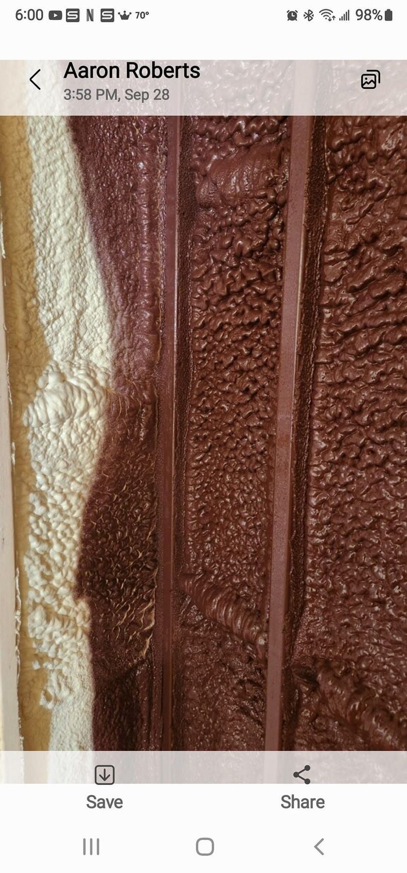 A close-up view of textured dark brown material with two vertical parallel lines against a lighter tan background.