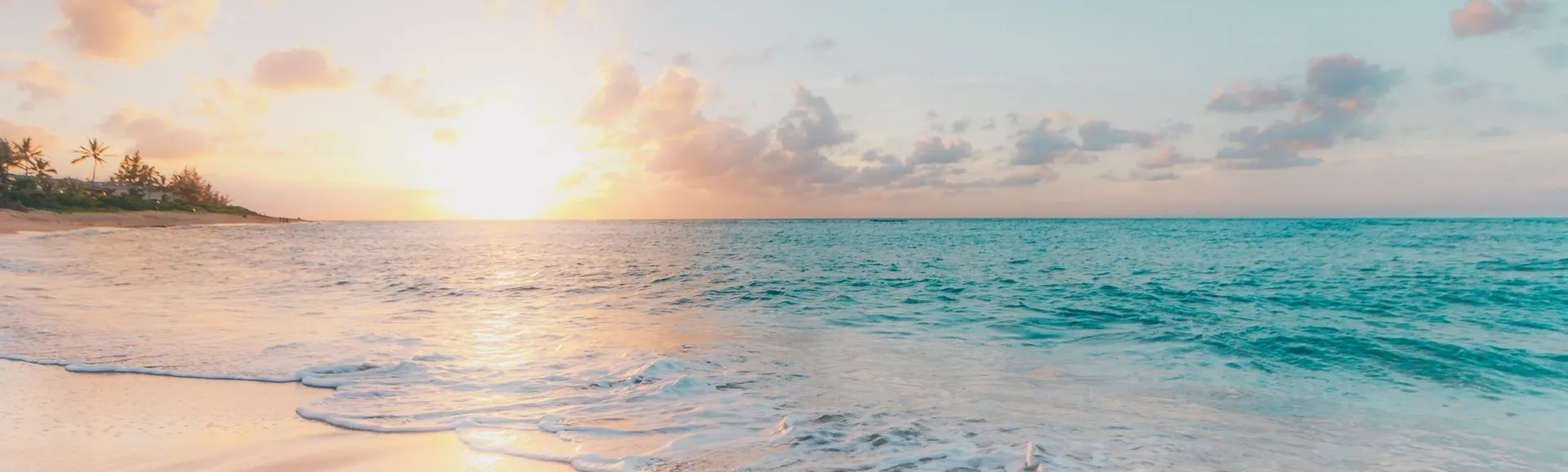 a blurry picture of a beach with a sunset in the background .