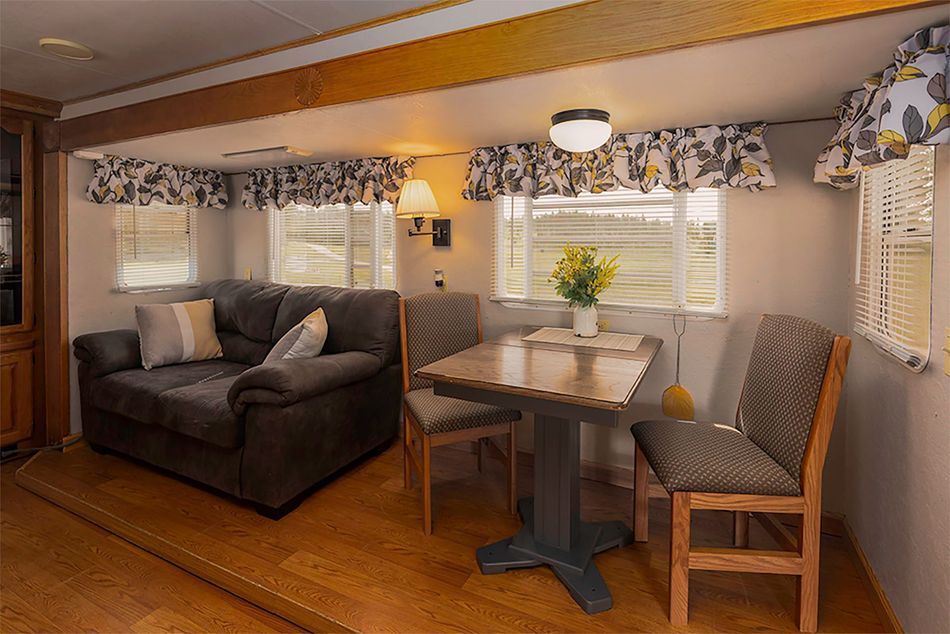 a living room with a couch , table and chairs .
