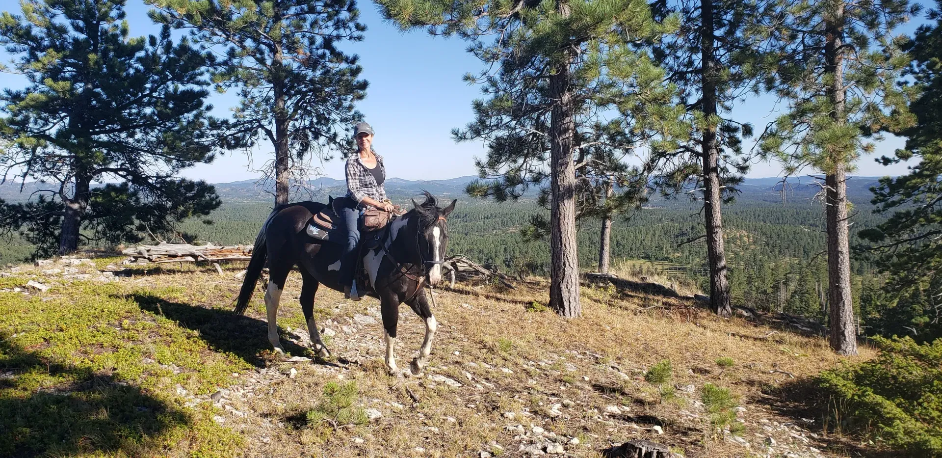 a person is riding a horse on a trail in the mountains .